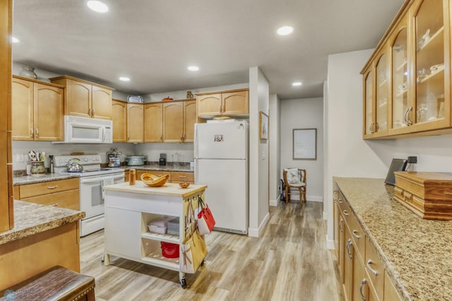 3327 23rd Ave S, Fargo, ND 58103 - kitchen featuring white appliances, light wood-style flooring, glass insert cabinets, light stone countertops, and recessed lighting