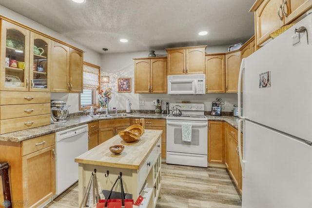 3327 23rd Ave S, Fargo, ND 58103 - kitchen with white appliances, butcher block counters, recessed lighting, glass insert cabinets, and light wood-type flooring