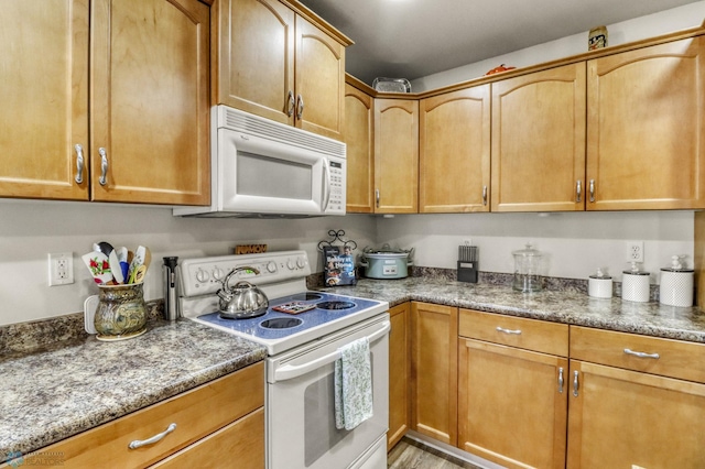3327 23rd Ave S, Fargo, ND 58103 - kitchen featuring white appliances and dark stone counters