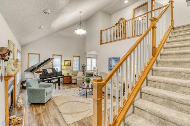 3327 23rd Ave S, Fargo, ND 58103 - living area with wood finished floors, stairway, recessed lighting, and high vaulted ceiling