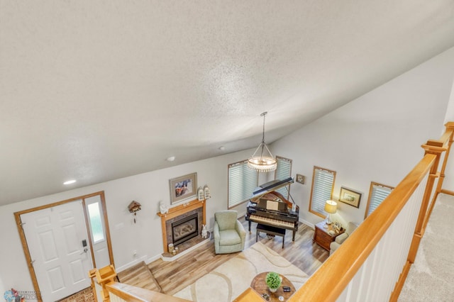 3327 23rd Ave S, Fargo, ND 58103 - living area featuring lofted ceiling, a tile fireplace, recessed lighting, and a textured ceiling