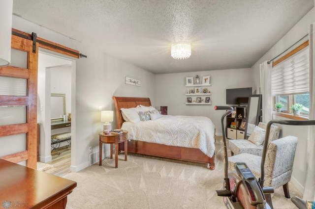 3327 23rd Ave S, Fargo, ND 58103 - bedroom featuring a barn door, a textured ceiling, and light colored carpet