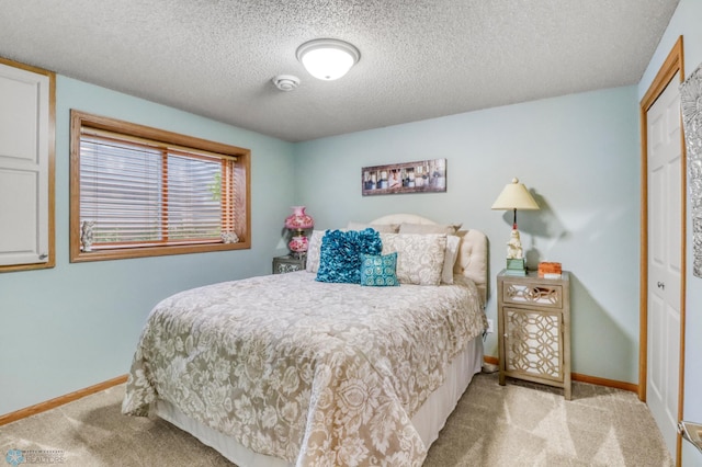 3327 23rd Ave S, Fargo, ND 58103 - bedroom featuring light carpet, a closet, and a textured ceiling