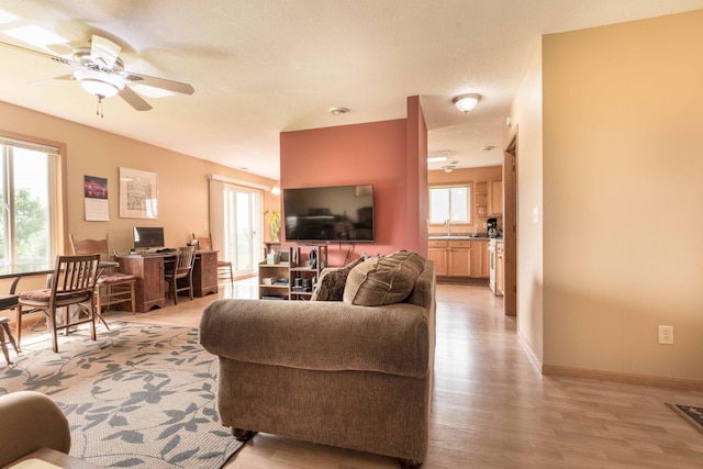 603 7th Ave, Osakis, MN 56360 - living area with a ceiling fan and light wood-style flooring