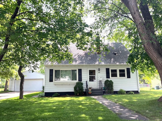 842 19th Ave N, Saint Cloud, MN 56303 - cape cod home featuring a detached garage, an outbuilding, a front lawn, and a shingled roof