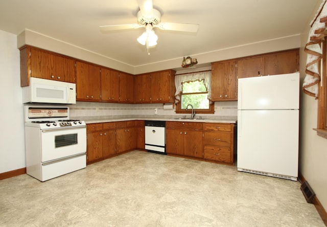 842 19th Ave N, Saint Cloud, MN 56303 - kitchen featuring white appliances, brown cabinetry, a ceiling fan, and light countertops