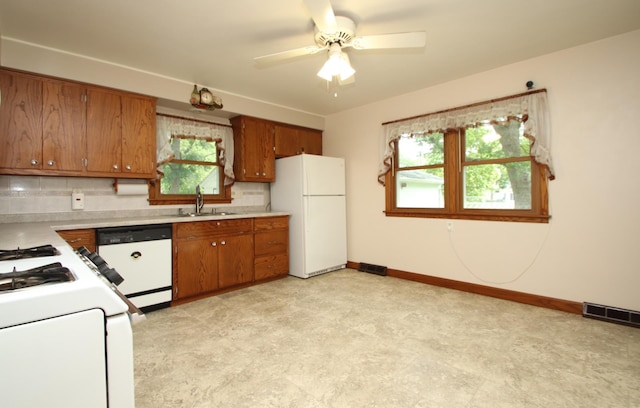 842 19th Ave N, Saint Cloud, MN 56303 - kitchen with white appliances, brown cabinets, light countertops, and healthy amount of natural light
