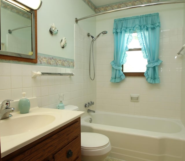 842 19th Ave N, Saint Cloud, MN 56303 - bathroom featuring shower / bathtub combination, vanity, tile walls, and wainscoting