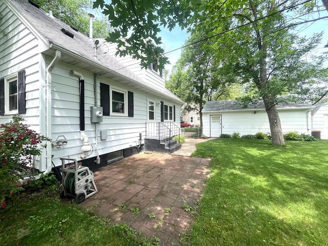 842 19th Ave N, Saint Cloud, MN 56303 - view of home's exterior with a yard, a patio area, and roof with shingles