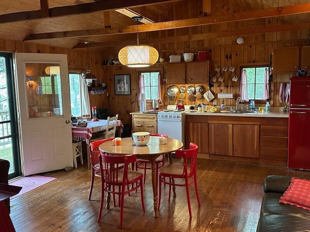 20519 485th St, Mcgregor, MN 55760 - dining space with wooden walls, wood-type flooring, and wood ceiling
