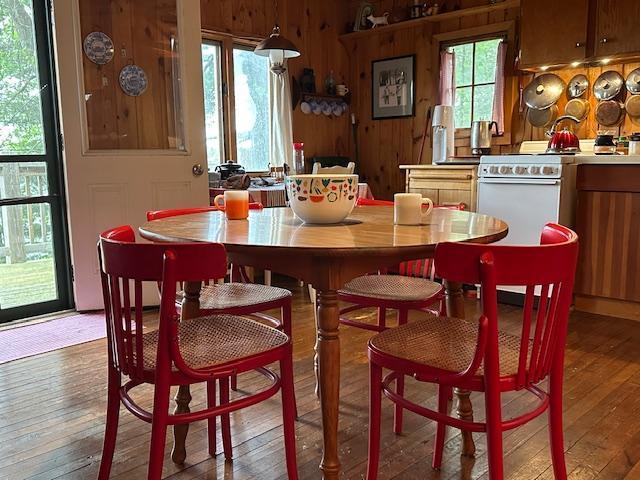 20519 485th St, Mcgregor, MN 55760 - dining room featuring light wood-style flooring and wood walls