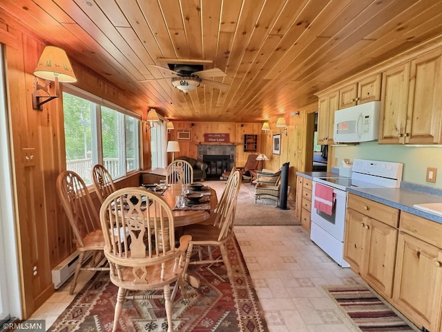 8243 Greer Ave NW, Maple Lake, MN 55358 - dining space with wood ceiling, wood walls, baseboard heating, a glass covered fireplace, and a ceiling fan