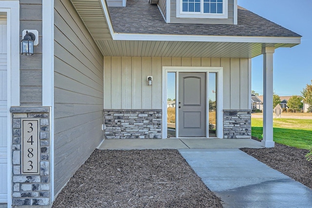 3483 Kady Ave NE, Saint Michael, MN 55376 - view of exterior entry with stone siding, a shingled roof, and a porch