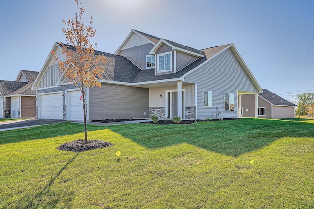 3483 Kady Ave NE, Saint Michael, MN 55376 - view of front facade featuring board and batten siding, a front yard, an attached garage, roof with shingles, and driveway