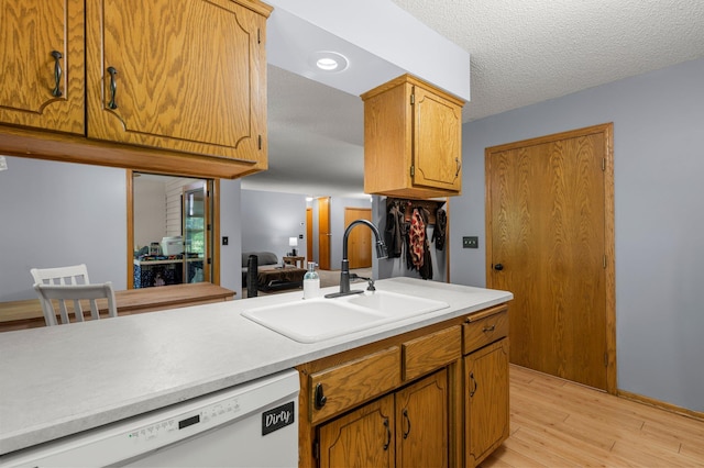 505 Brookview Ln SW, Isanti, MN 55040 - kitchen with dishwasher, light countertops, light wood finished floors, a textured ceiling, and brown cabinetry