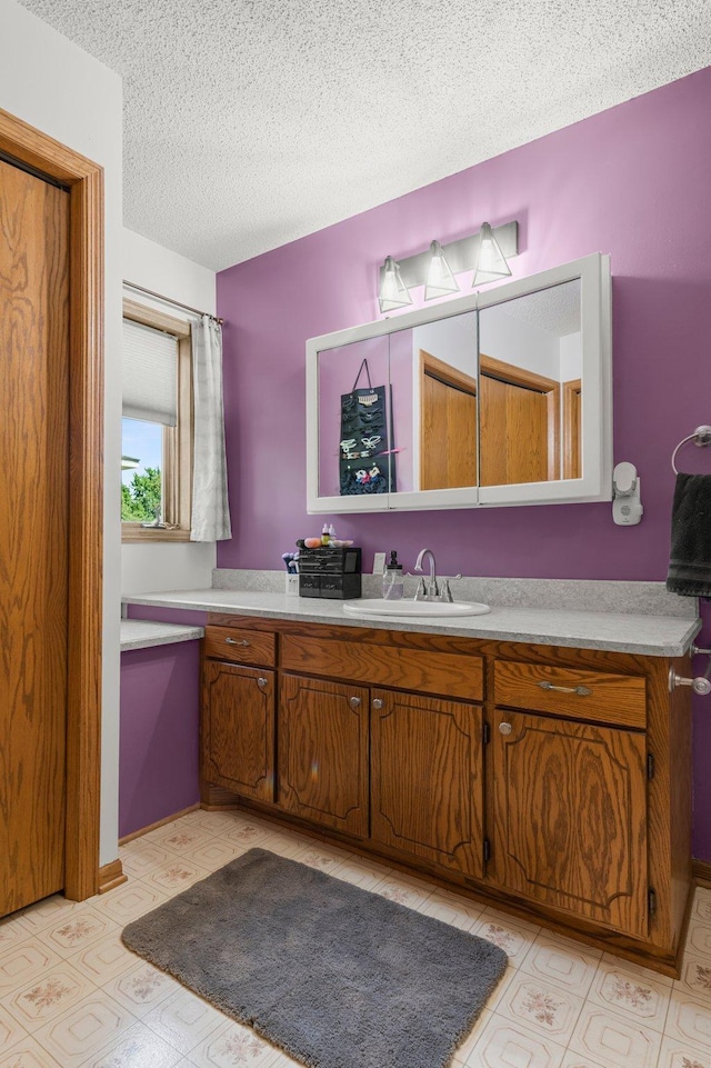 505 Brookview Ln SW, Isanti, MN 55040 - bathroom with a textured ceiling, vanity, and tile patterned floors