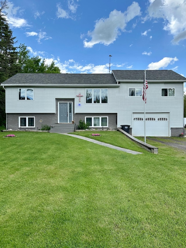 5735 County Road 1, Littlefork, MN 56653 - bi-level home with a garage, driveway, and a front lawn