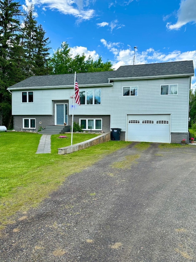 5735 County Road 1, Littlefork, MN 56653 - raised ranch featuring a garage, driveway, and a front yard