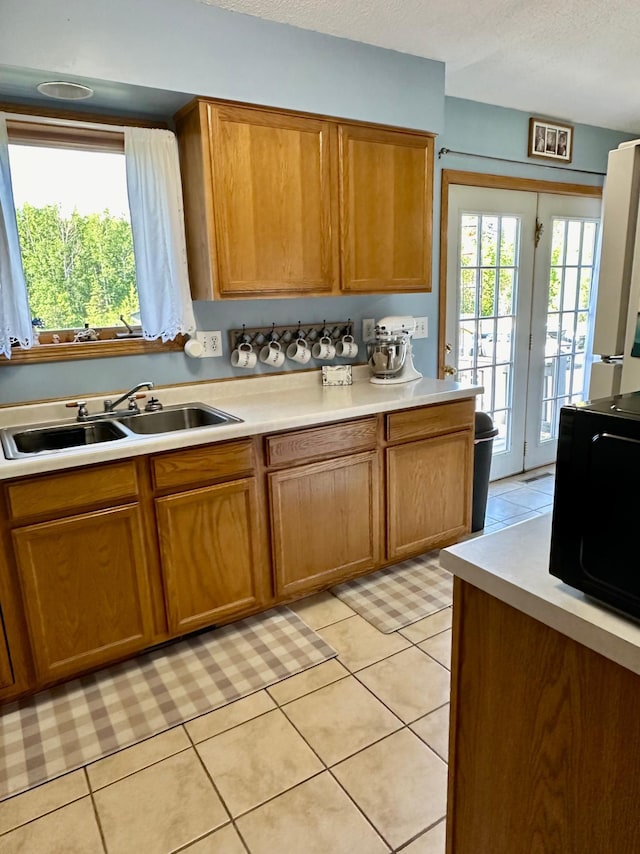 5735 County Road 1, Littlefork, MN 56653 - kitchen featuring black microwave, light countertops, light tile patterned flooring, and a textured ceiling