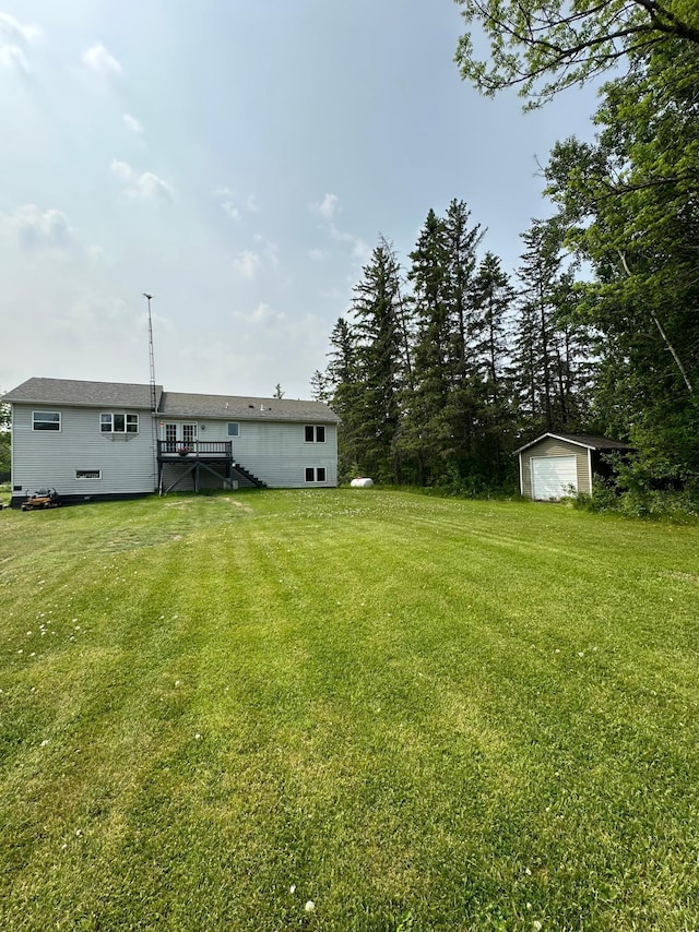 5735 County Road 1, Littlefork, MN 56653 - view of green lawn featuring a shed, a detached garage, and stairway
