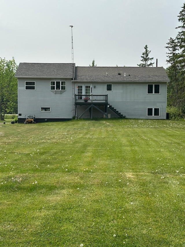 5735 County Road 1, Littlefork, MN 56653 - back of house featuring stairway, a wooden deck, and a lawn