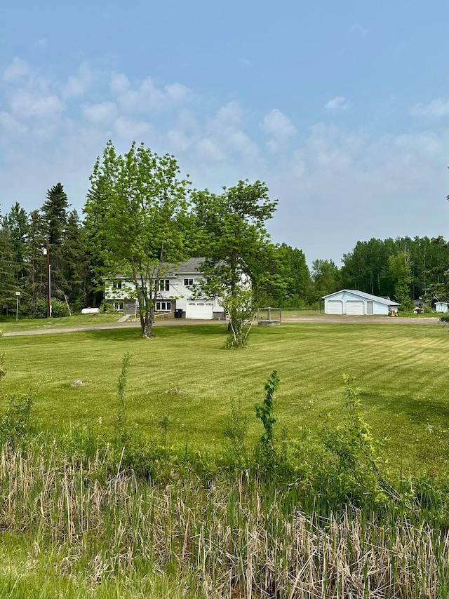 5735 County Road 1, Littlefork, MN 56653 - view of green lawn with a detached garage and an outdoor structure