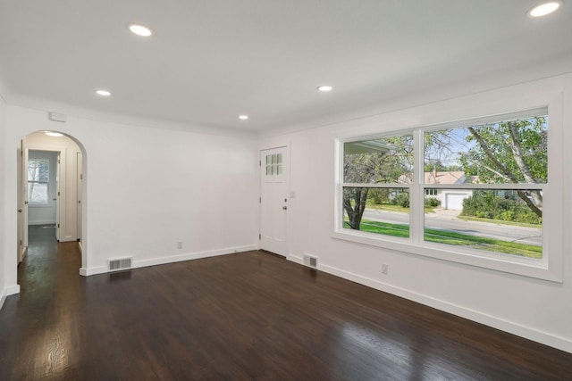 242 Butler Ave W, West Saint Paul, MN 55118 - empty room featuring plenty of natural light, arched walkways, recessed lighting, and dark wood finished floors