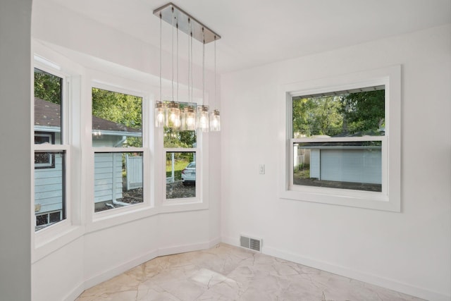 242 Butler Ave W, West Saint Paul, MN 55118 - unfurnished dining area featuring light marble finish floors and healthy amount of natural light