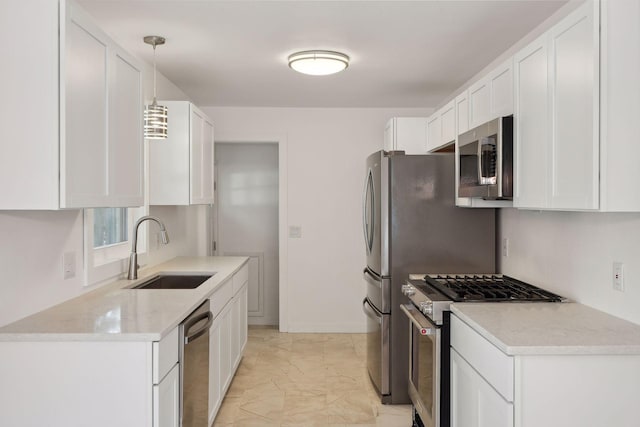 242 Butler Ave W, West Saint Paul, MN 55118 - kitchen featuring appliances with stainless steel finishes, light marble finish flooring, white cabinets, and pendant lighting