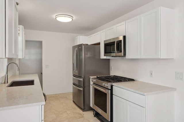242 Butler Ave W, West Saint Paul, MN 55118 - kitchen featuring appliances with stainless steel finishes, light marble finish flooring, white cabinets, and light countertops
