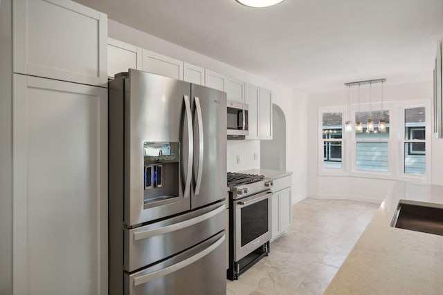 242 Butler Ave W, West Saint Paul, MN 55118 - kitchen with appliances with stainless steel finishes, light countertops, white cabinets, and pendant lighting