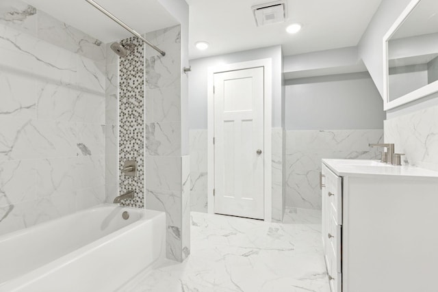 242 Butler Ave W, West Saint Paul, MN 55118 - bathroom with vanity, marble finish flooring, shower / bathtub combination, tile walls, and wainscoting