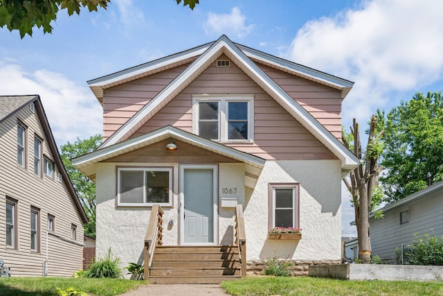 1067 Van Buren Ave, Saint Paul, MN 55104 - bungalow-style home featuring entry steps and stucco siding