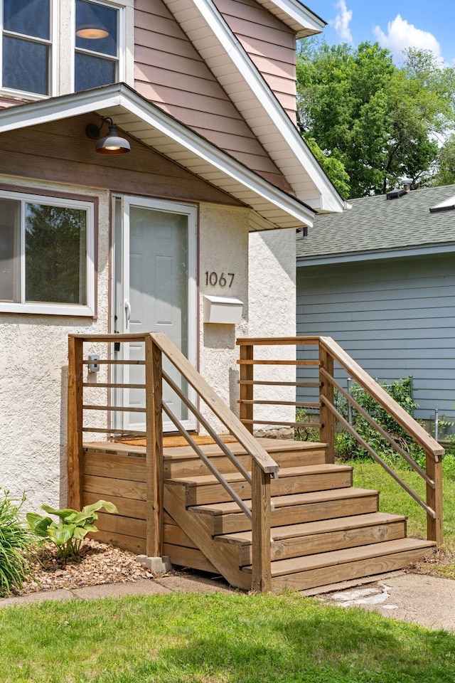 1067 Van Buren Ave, Saint Paul, MN 55104 - doorway to property featuring stucco siding and roof with shingles