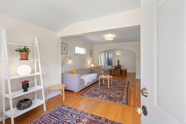 1067 Van Buren Ave, Saint Paul, MN 55104 - living area with arched walkways, wood finished floors, and vaulted ceiling