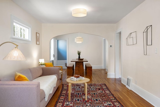 1067 Van Buren Ave, Saint Paul, MN 55104 - living room with arched walkways and wood finished floors