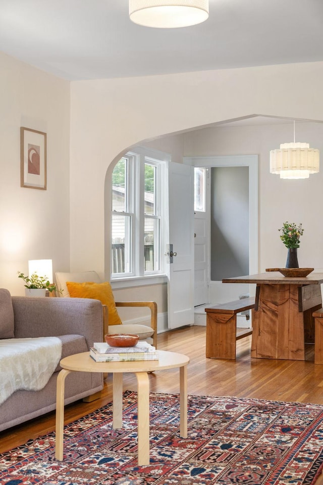 1067 Van Buren Ave, Saint Paul, MN 55104 - living room with light wood-type flooring and arched walkways