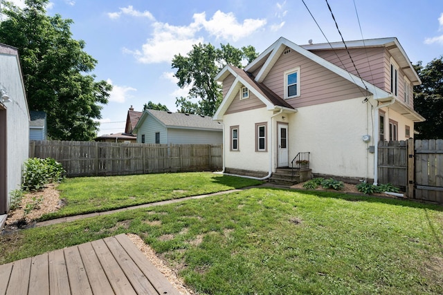 1067 Van Buren Ave, Saint Paul, MN 55104 - rear view of house with a fenced backyard and stucco siding