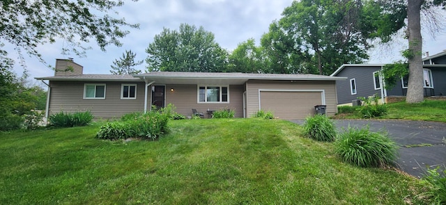 1430 Cardinal Cv, Chaska, MN 55318 - ranch-style house featuring a garage, driveway, a front lawn, and a chimney