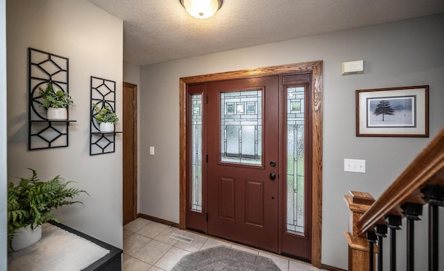 452 Spruce St, Shakopee, MN 55379 - entrance foyer featuring light tile patterned flooring, a textured ceiling, and stairs