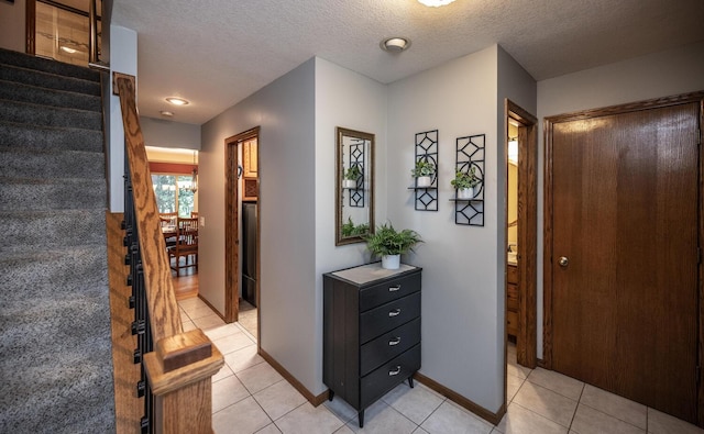 452 Spruce St, Shakopee, MN 55379 - entrance foyer with light tile patterned flooring, stairs, and a textured ceiling
