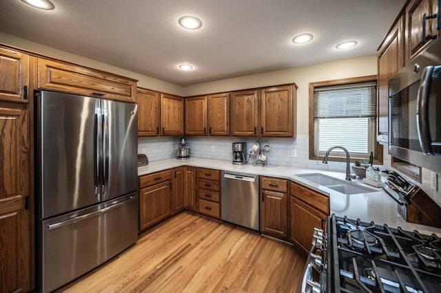 452 Spruce St, Shakopee, MN 55379 - kitchen with stainless steel appliances, light wood-type flooring, brown cabinets, backsplash, and recessed lighting