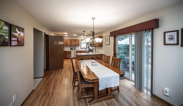 452 Spruce St, Shakopee, MN 55379 - dining area featuring a chandelier and light wood-style floors
