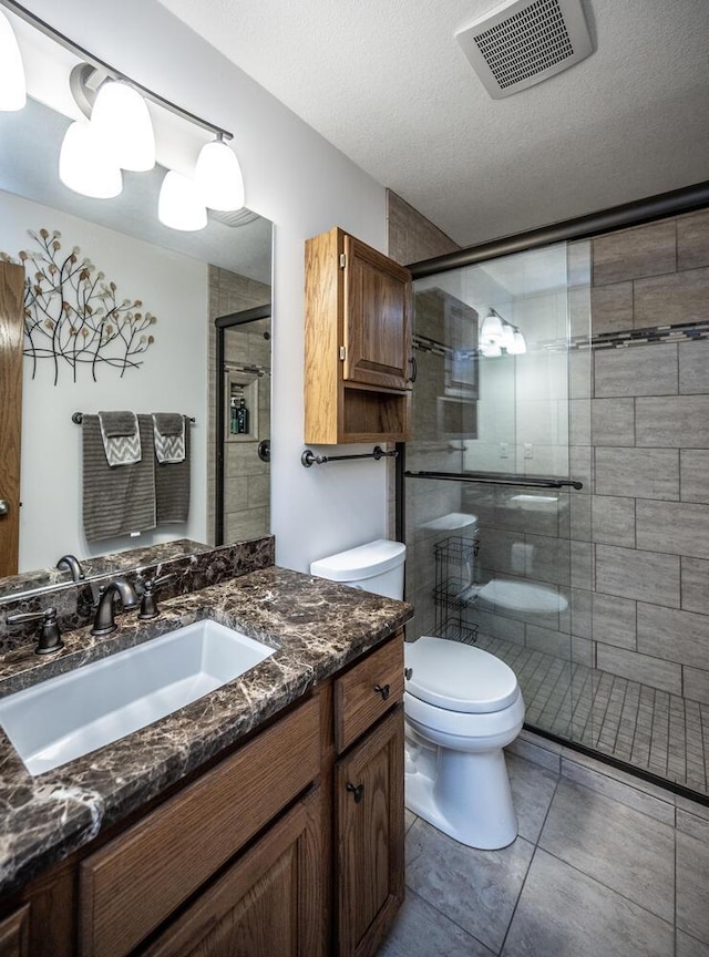452 Spruce St, Shakopee, MN 55379 - bathroom with a shower stall, vanity, tile patterned flooring, and a textured ceiling