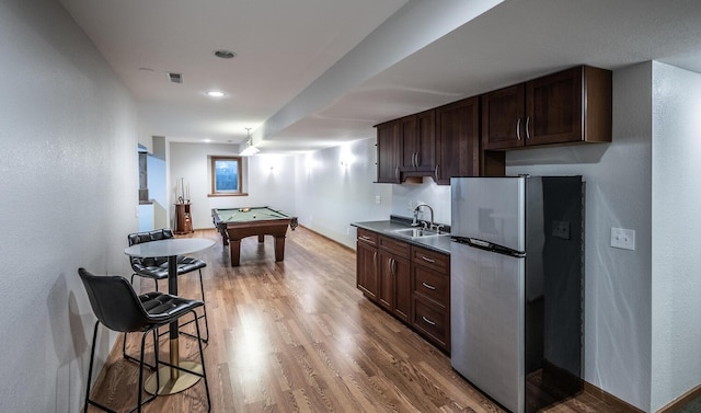 452 Spruce St, Shakopee, MN 55379 - kitchen with freestanding refrigerator, dark brown cabinetry, billiards table, light wood-type flooring, and dark countertops
