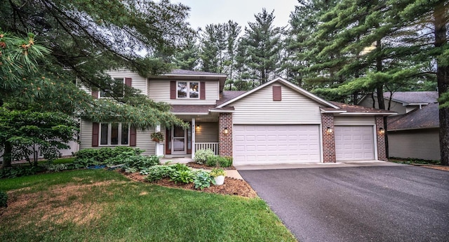 452 Spruce St, Shakopee, MN 55379 - traditional-style home featuring a garage, driveway, brick siding, a front yard, and a porch