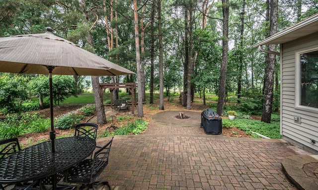 452 Spruce St, Shakopee, MN 55379 - view of patio / terrace featuring outdoor dining area, a fire pit, and view of wooded area
