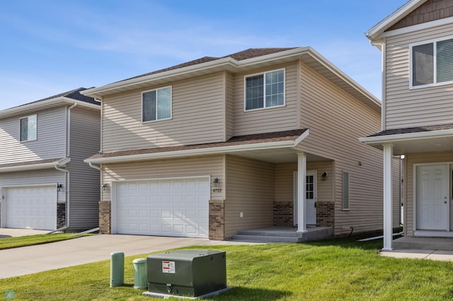 4722 35th Ave S, Fargo, ND 58104 - view of front of house with an attached garage, a front yard, and concrete driveway