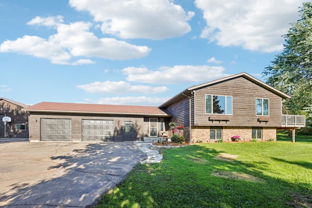 733 Meadow Dr, Hudson, WI 54016 - tri-level home featuring concrete driveway, a garage, a front yard, and brick siding