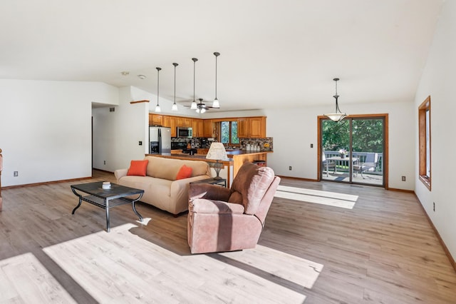 733 Meadow Dr, Hudson, WI 54016 - living room with vaulted ceiling, light wood-style floors, and a ceiling fan
